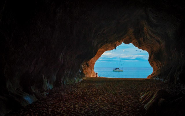 View from a cave of a yacht.